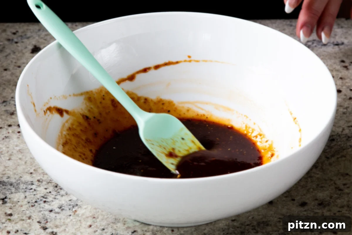 Spicy Gochujang Tofu Sandwich 8 Gochujang marinade ingredients in the bowl after mixing, a smooth, red sauce.