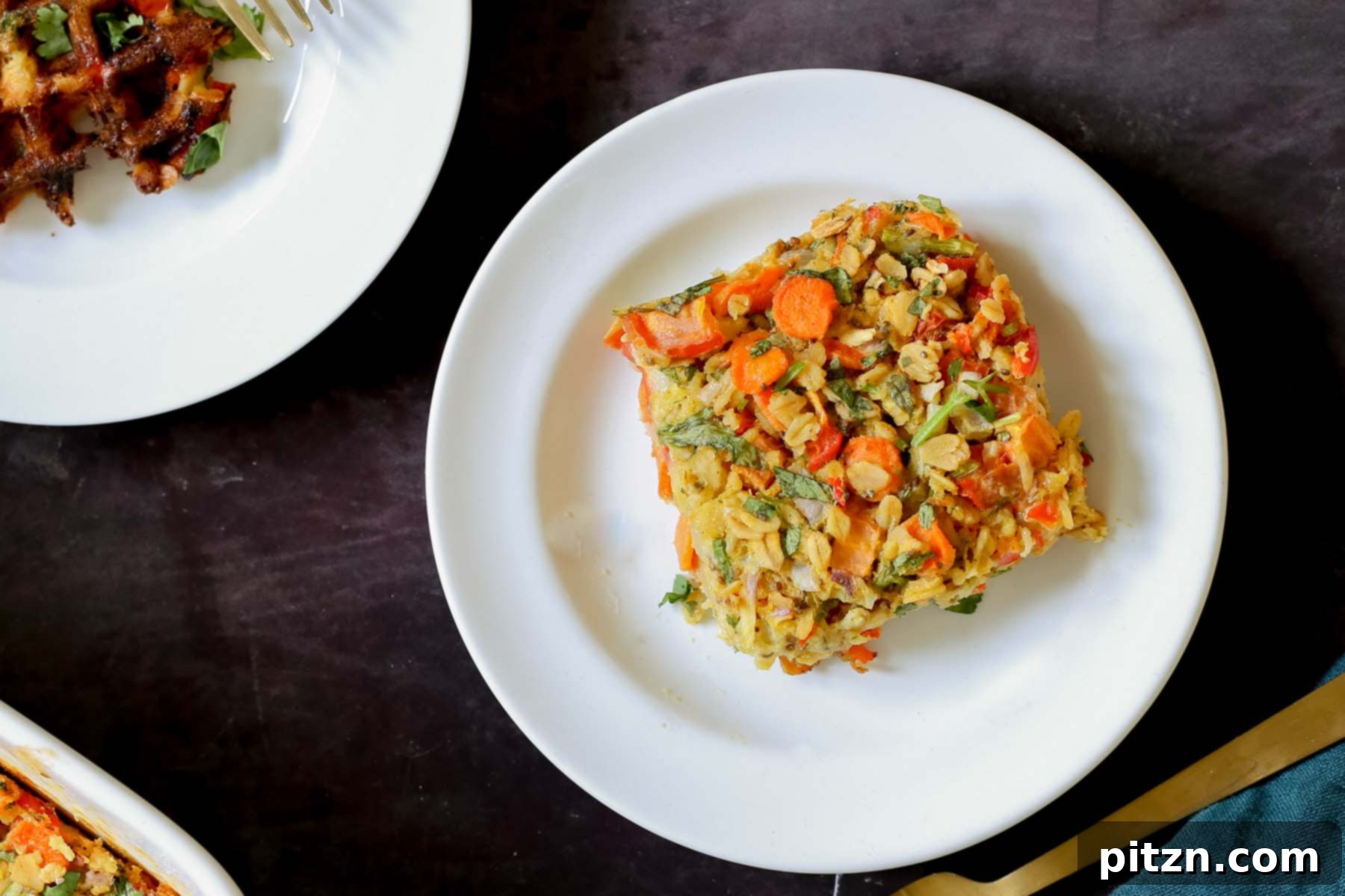 Vegan Savory Vegetable Baked Oats 12 a beautifully plated piece of savory baked oatmeal on a white dish, surrounded by other breakfast items and condiments