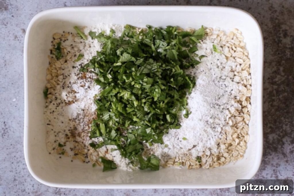 Vegan Savory Vegetable Baked Oats 7 oats, flour, seeds, and cilantro are neatly arranged in the baking pan before mixing
