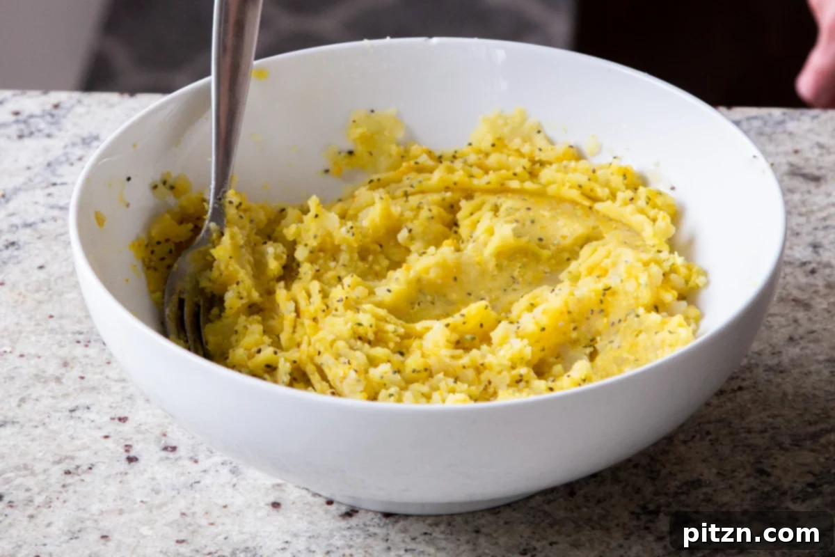 The fully mixed and seasoned potato filling for Aloo Paratha, appearing cohesive and flavorful in a bowl, ready for stuffing.