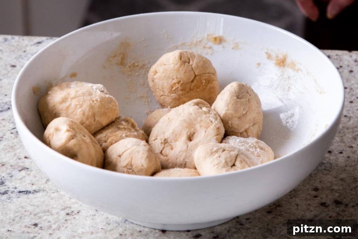 Evenly portioned balls of multigrain paratha dough arranged in a bowl, ready for rolling and stuffing.
