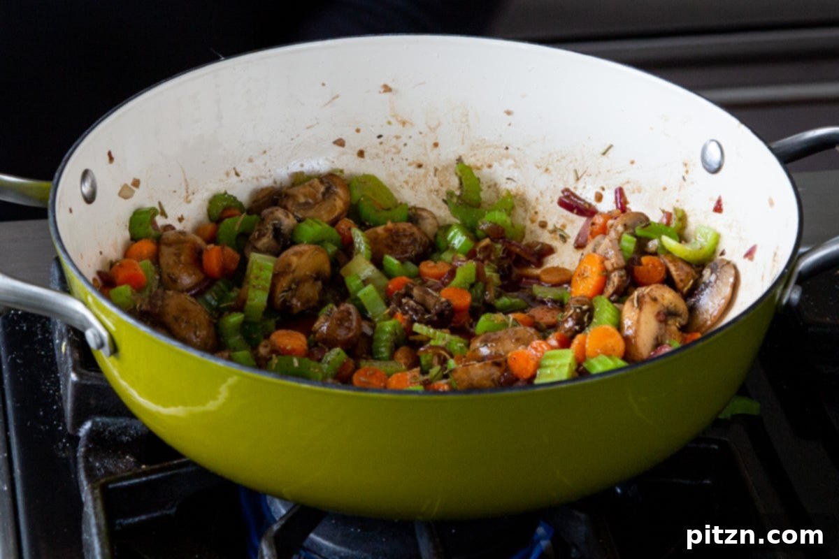 Hearty One-Pot Mushroom Noodle Delight 13 The flavorful mushroom mixture in the pan after all the spices and sauces have been added and cooked.