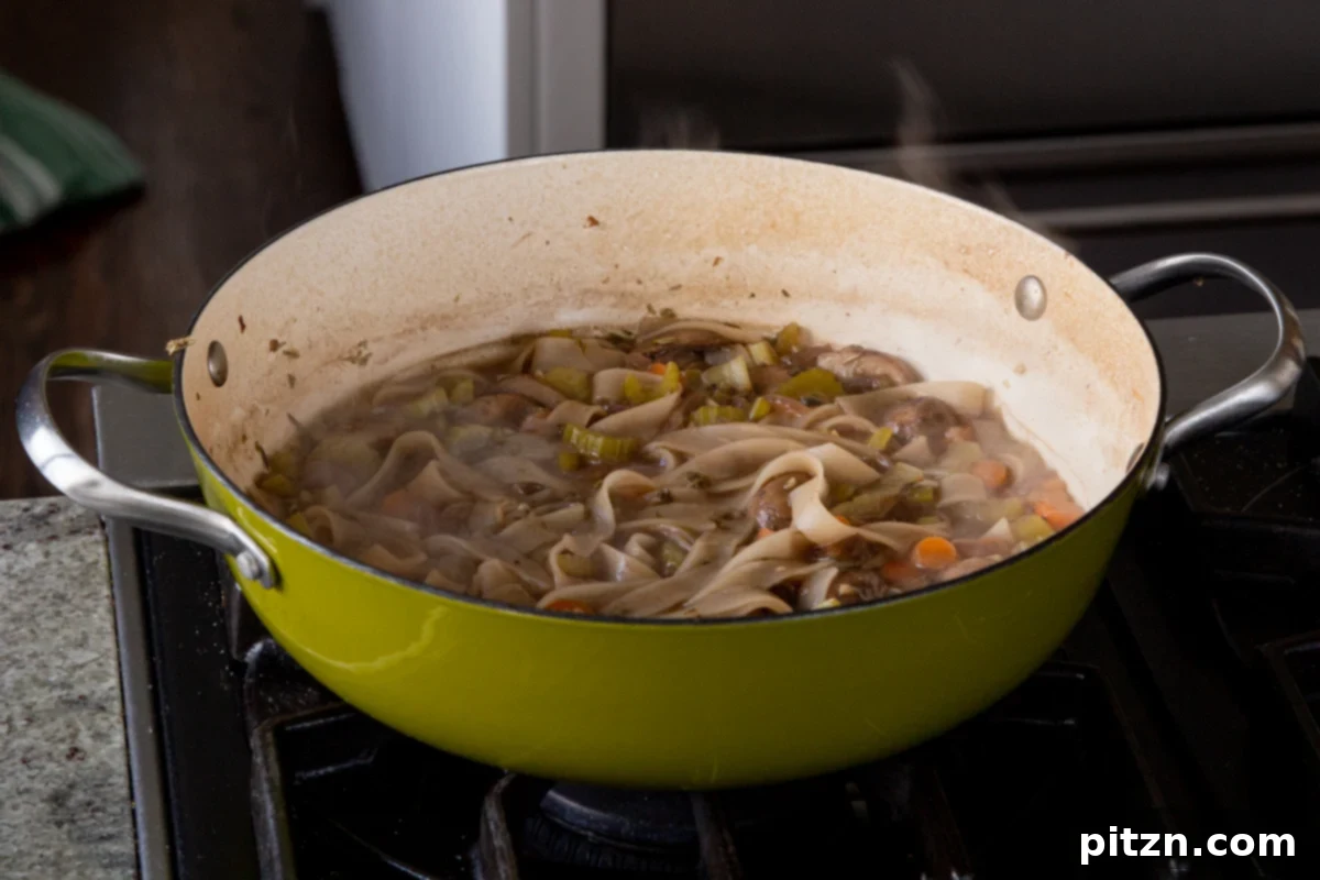 Hearty One-Pot Mushroom Noodle Delight 16 The finished mushroom noodle soup, perfectly cooked and ready to be served from the pan.