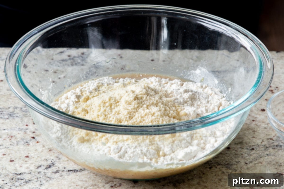 Decadent Carrot Halwa Gateau 14 All-purpose and almond flours in a mixing bowl, forming the dry base for the cake.