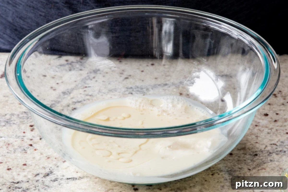 Decadent Carrot Halwa Gateau 16 Non-dairy milk in a bowl, forming the liquid base for the cake batter.