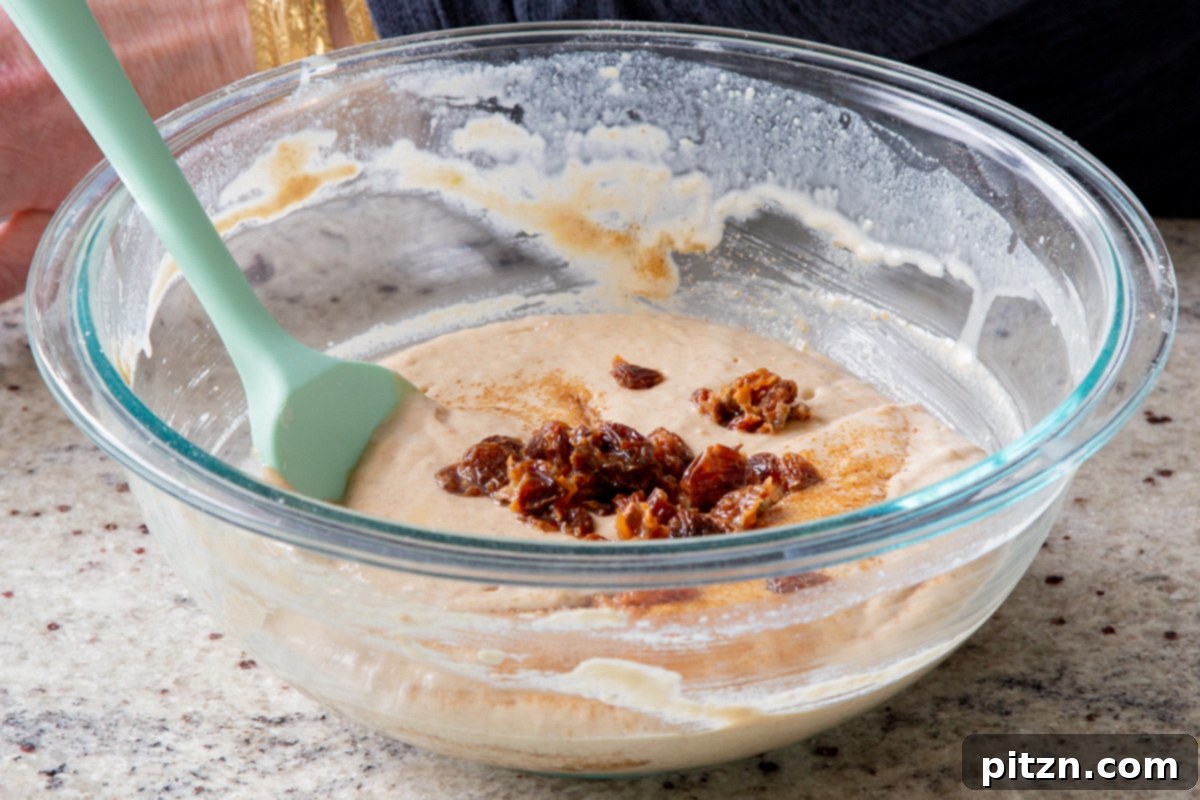 Decadent Carrot Halwa Gateau 22 Adding the plump, soaked raisins to the cake batter, distributing their sweetness.