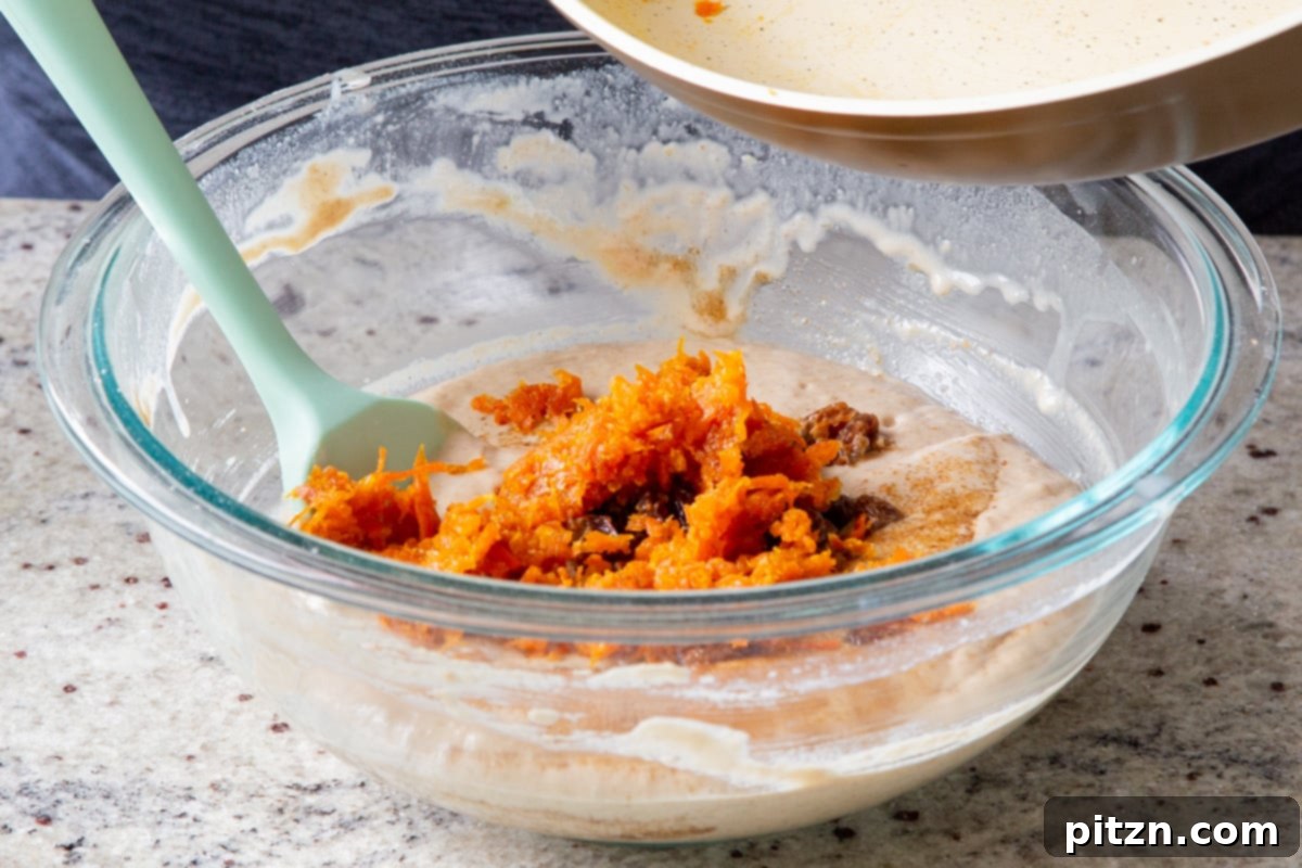 Decadent Carrot Halwa Gateau 23 Gently folding a portion of the caramelized carrot halwa into the cake batter.
