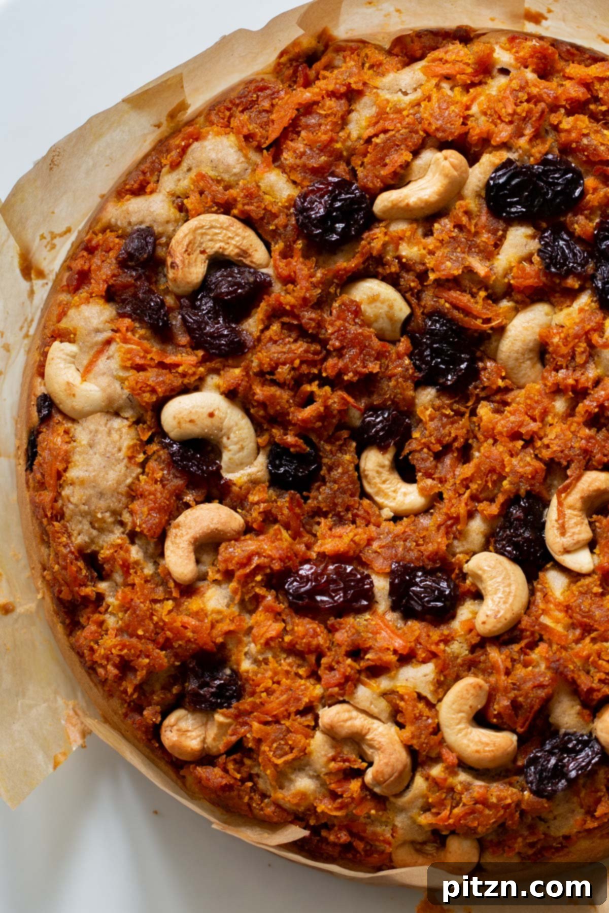 Decadent Carrot Halwa Gateau 4 Overhead photo of a whole vegan carrot halwa cake before slicing, garnished with fresh mint leaves.