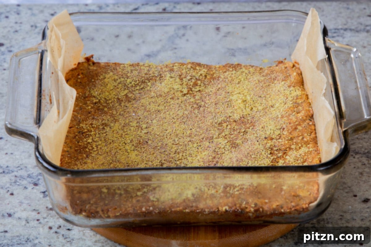 Doritos Nacho Crunch Bars 15 A pan of savory granola bar dough with the flavor topping generously sprinkled on