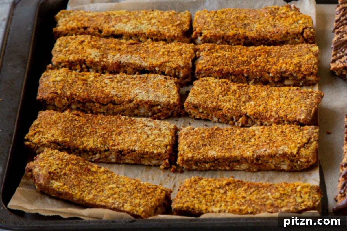 Doritos Nacho Crunch Bars 18 Sliced savory granola bars on a lined baking sheet, ready for an optional second bake for extra crispness