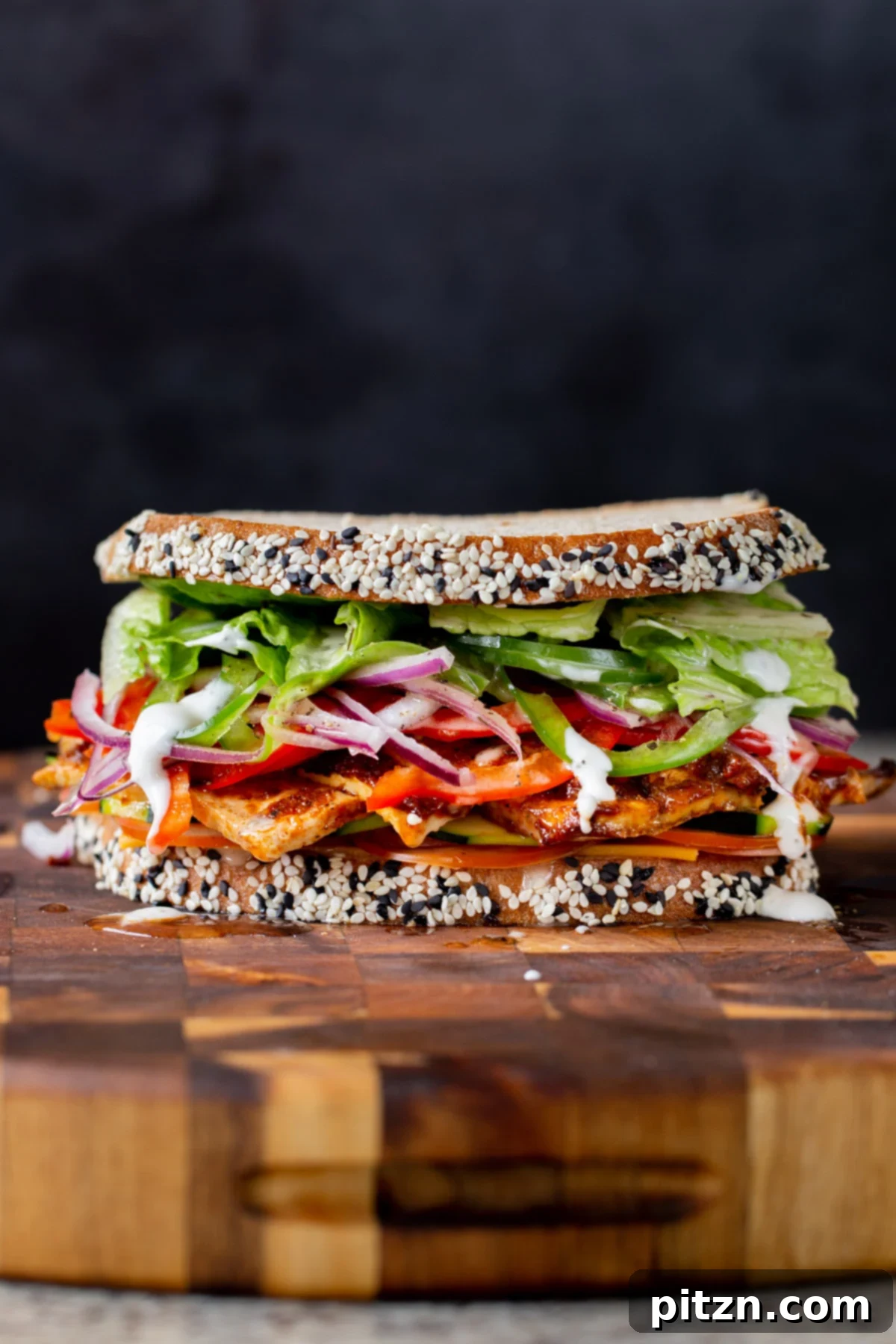 Plant-Based Deli Club 2 A veggie- and protein-packed vegan club sandwich with homemade tofu deli meat on a wooden cutting board, ready to be enjoyed.