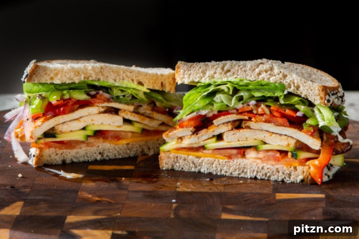 Plant-Based Deli Club 20 A perfectly sliced vegan club sandwich, revealing its colorful and delicious layers of fresh vegetables and homemade tofu deli meat.