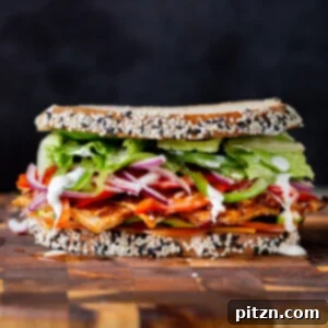 Plant-Based Deli Club 5 A vibrant vegan club sandwich with fresh veggies and savory tofu deli meat, presented on a wooden cutting board.
