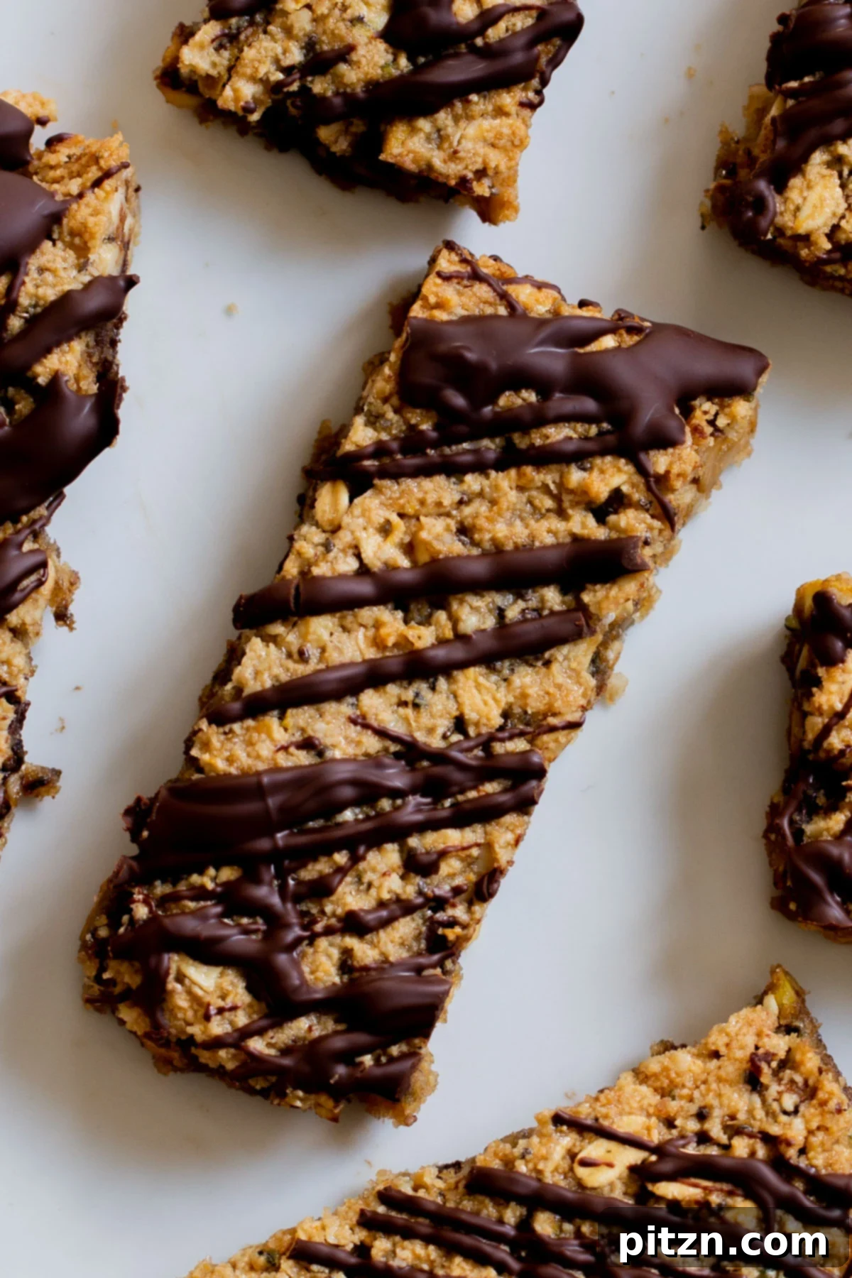 Perfectly Crisp Granola Bars 2 close-up of crunchy granola bars with chocolate topping on a white plate