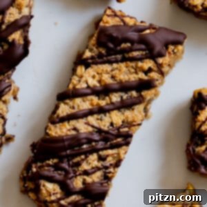 close-up of crunchy granola bars with chocolate topping on a white plate