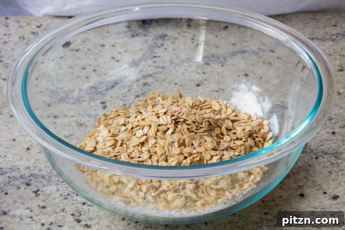 Perfectly Crisp Granola Bars 8 adding oats to the bowl