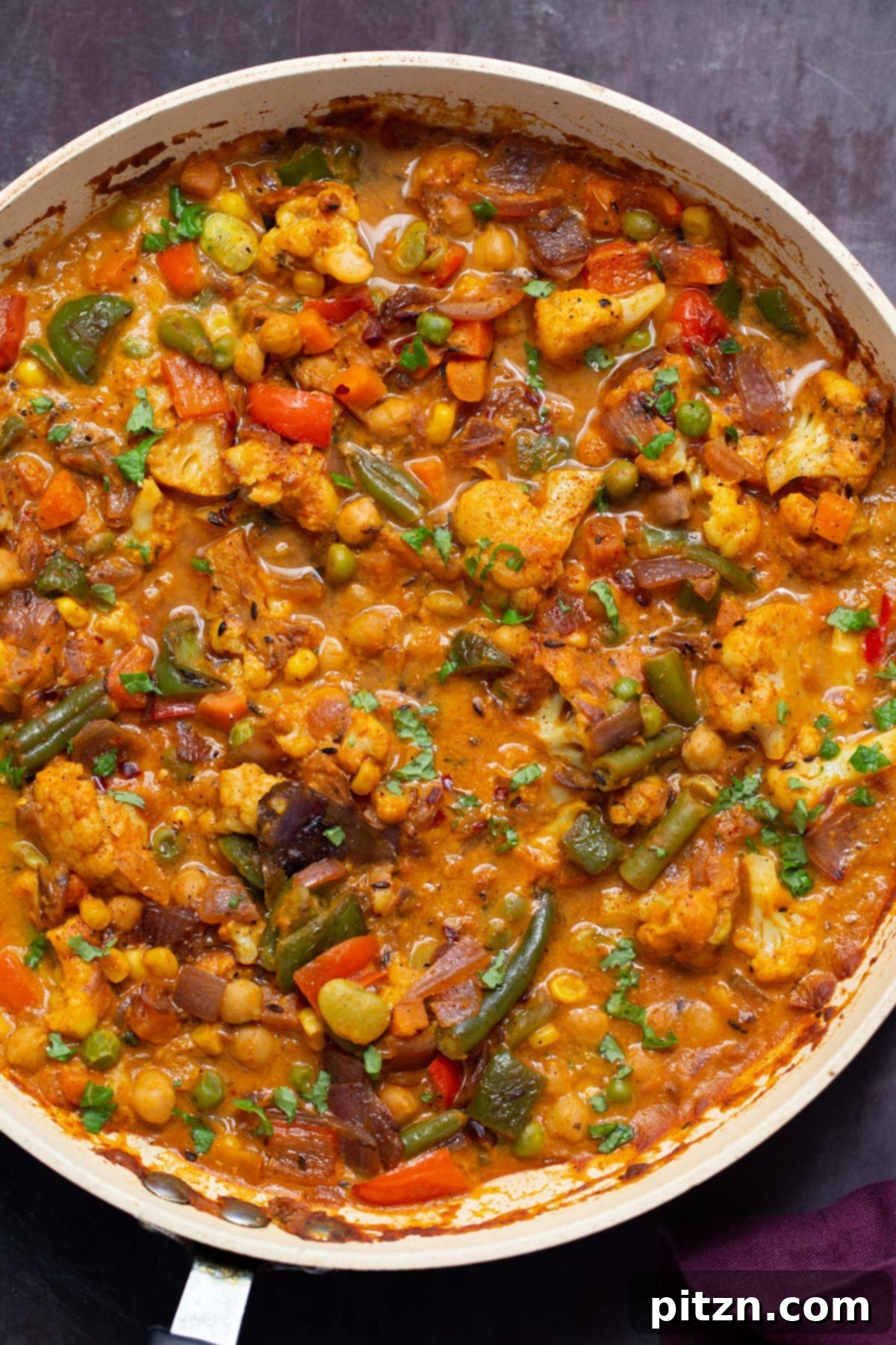 North Indian Restaurant Bhuna: A Vegetarian Curry Classic 2 vegetable bhuna in the frying pan, garnished with fresh cilantro