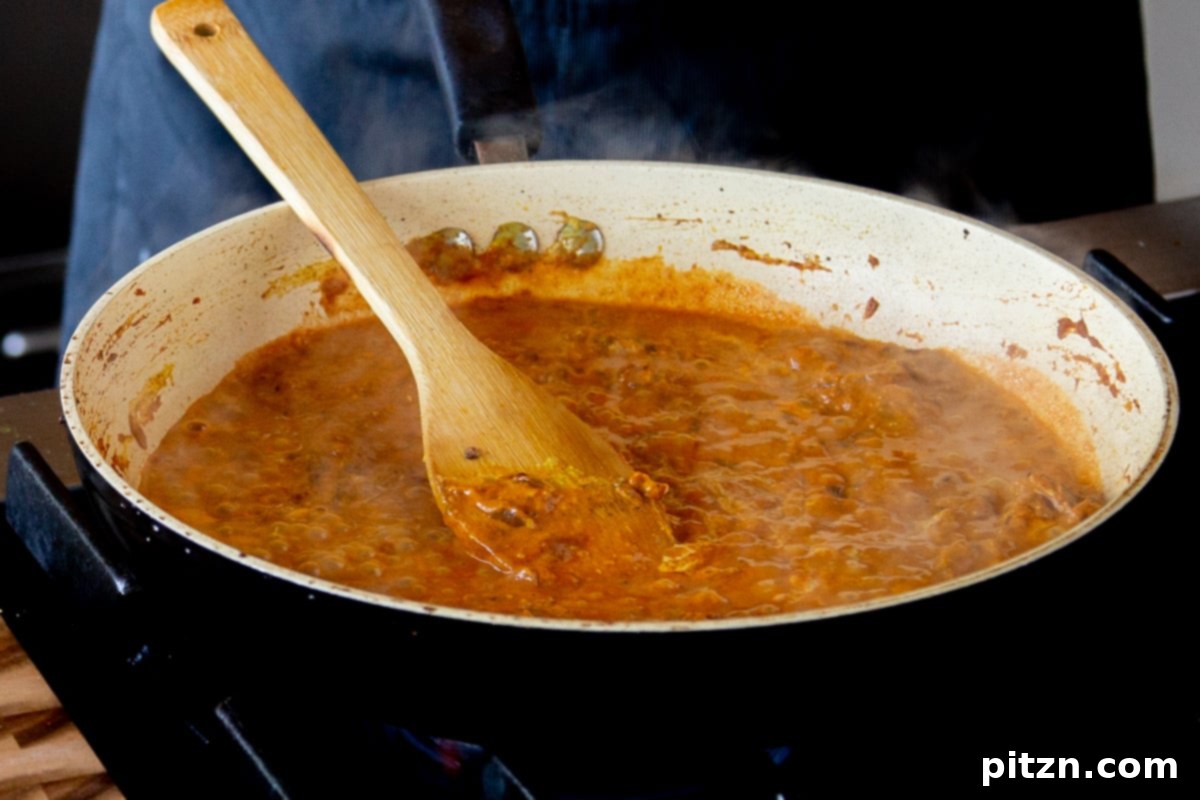 North Indian Restaurant Bhuna: A Vegetarian Curry Classic 13 bhuna sauce simmering after adding water, showing a rich, thick consistency