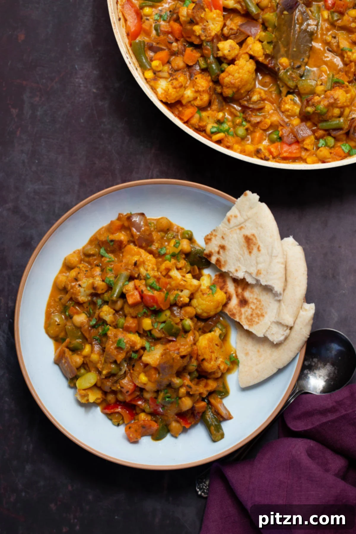 North Indian Restaurant Bhuna: A Vegetarian Curry Classic 3 plate of vegetable bhuna next to the pan, with naan bread on the side