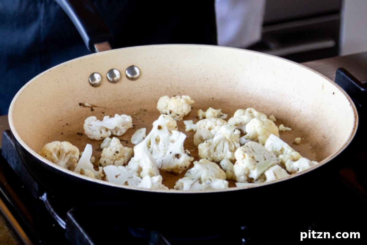 North Indian Restaurant Bhuna: A Vegetarian Curry Classic 7 cooking the cauliflower and fenugreek in a hot pan