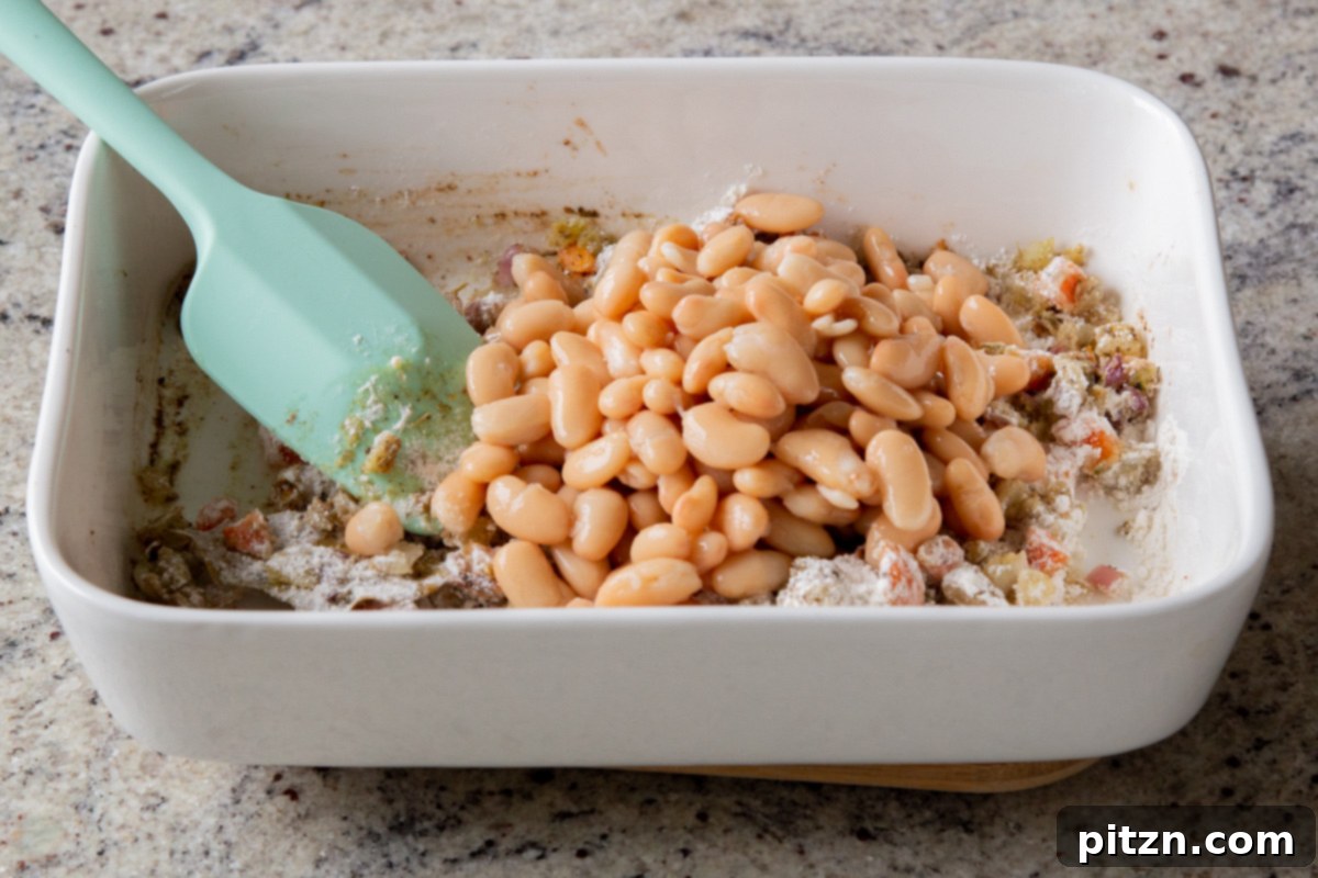 Everything Bagel Pot Pie Remix 13 Adding protein-rich white beans to the flavorful vegetable mixture in the pan