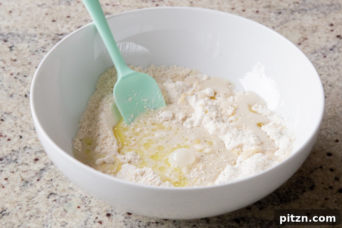 Everything Bagel Pot Pie Remix 18 Adding wet ingredients, including non-dairy milk and oil, to the dry biscuit mixture