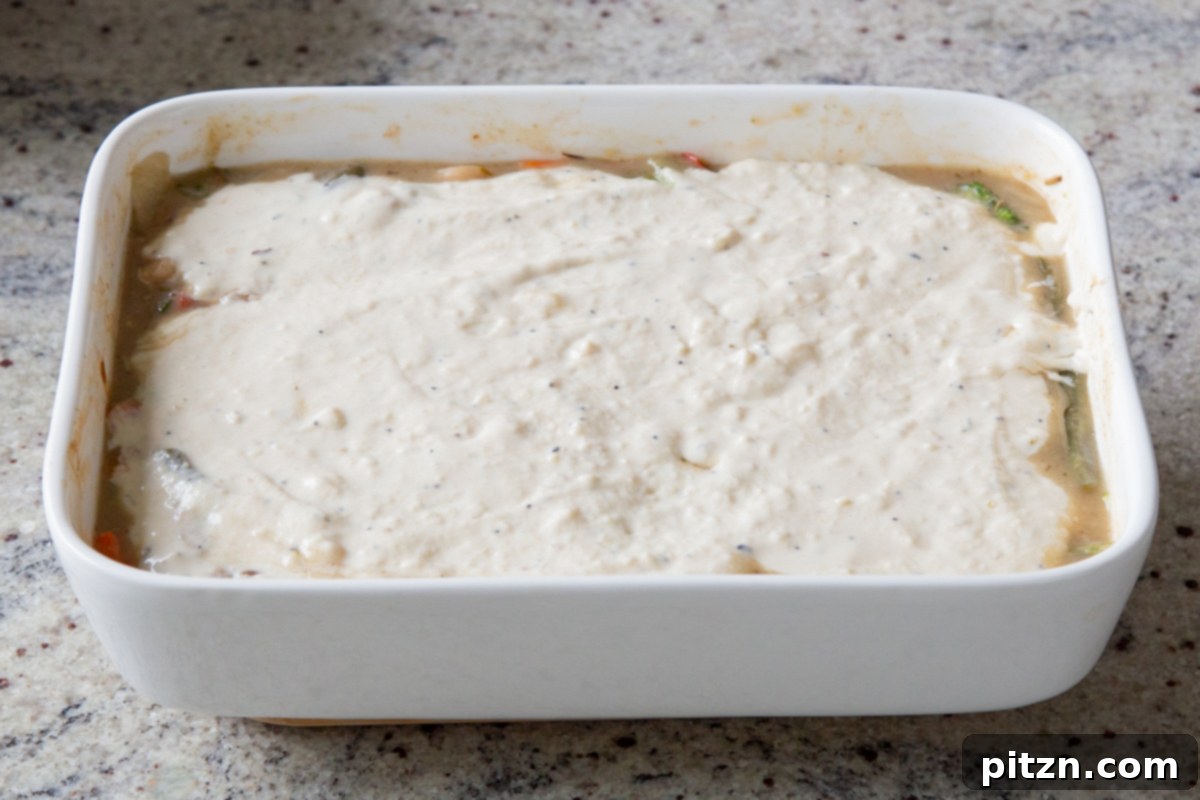 Everything Bagel Pot Pie Remix 20 Biscuit dough evenly spread on top of the pot pie filling in the baking pan