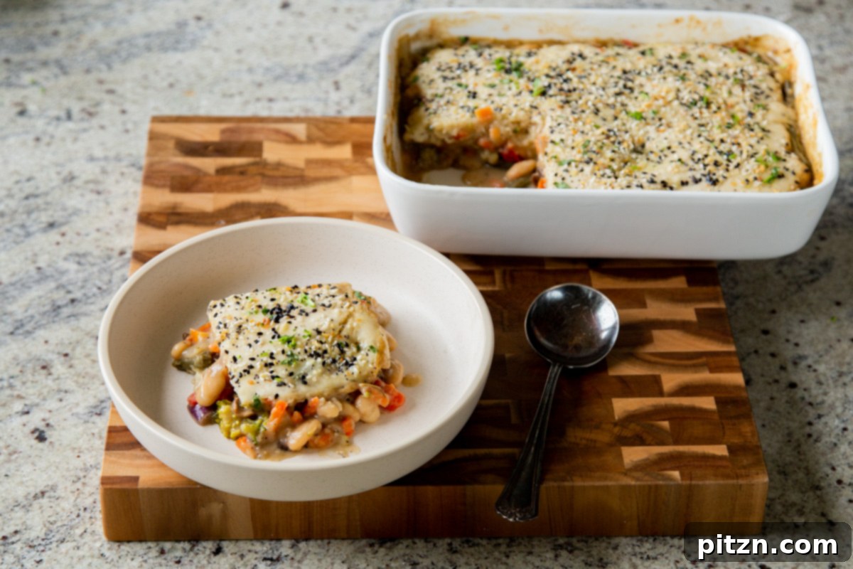 Everything Bagel Pot Pie Remix 22 A perfectly baked piece of everything bagel pot pie presented next to the baking pan