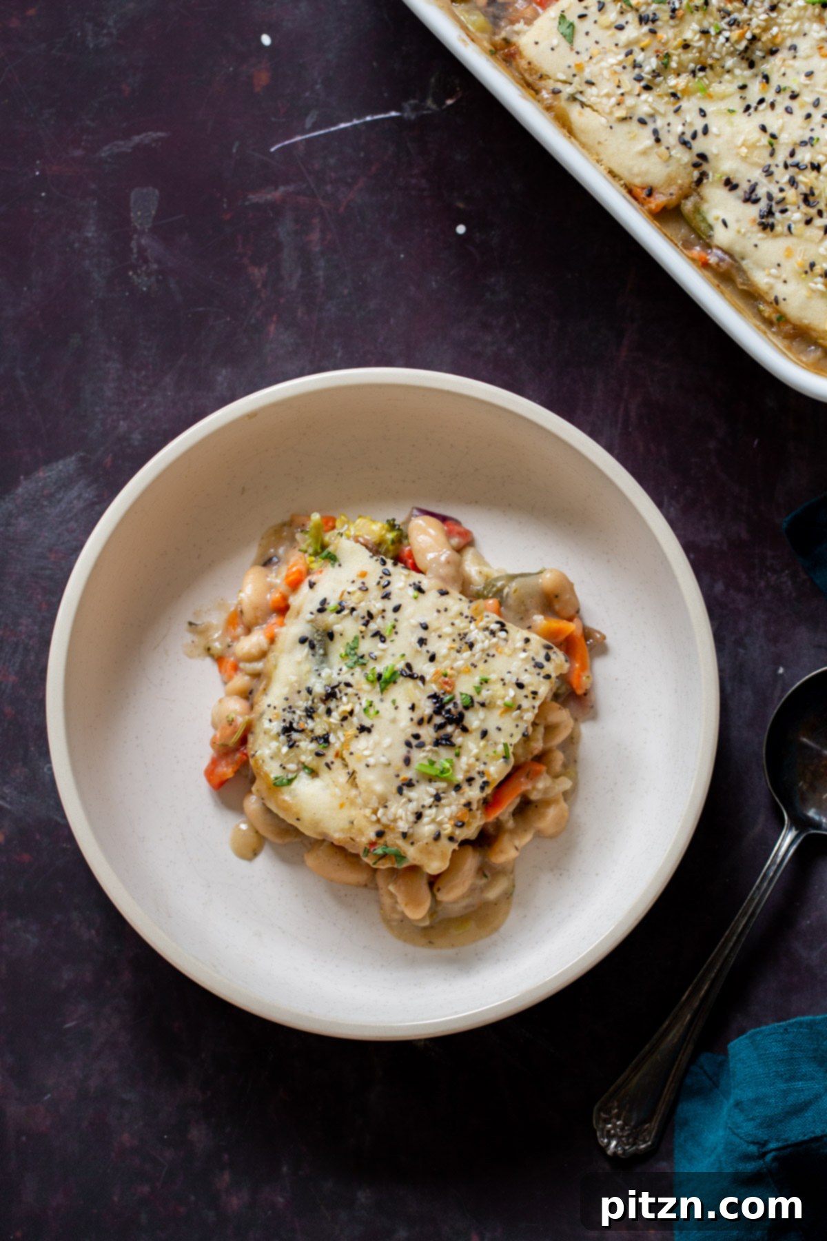 Everything Bagel Pot Pie Remix 5 A plate of everything bagel pot pie next to the baking pan, showing a generous serving