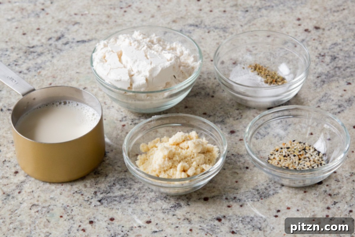 Everything Bagel Pot Pie Remix 8 Biscuit topping ingredients laid out in bowls on a kitchen counter, showcasing flours, spices, and non-dairy milk