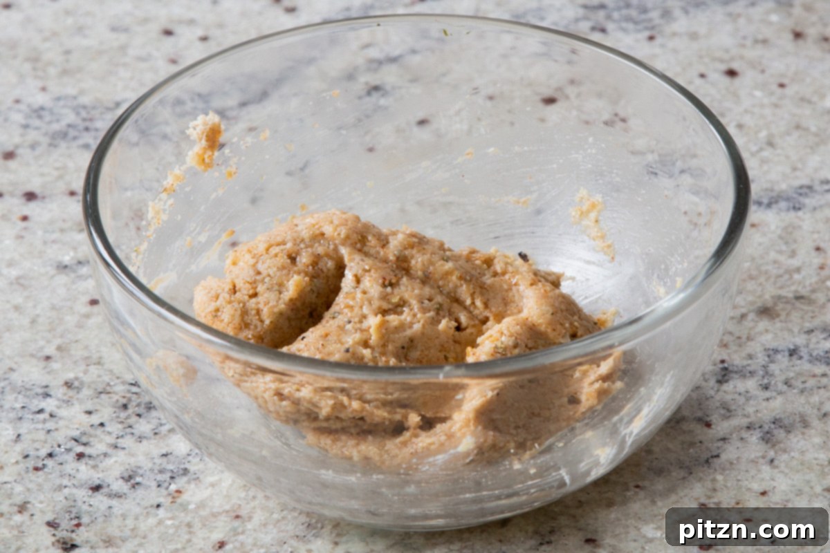 The fully mixed almond flour crouton dough, showcasing its cohesive and slightly textured consistency, ready to be shaped and baked.