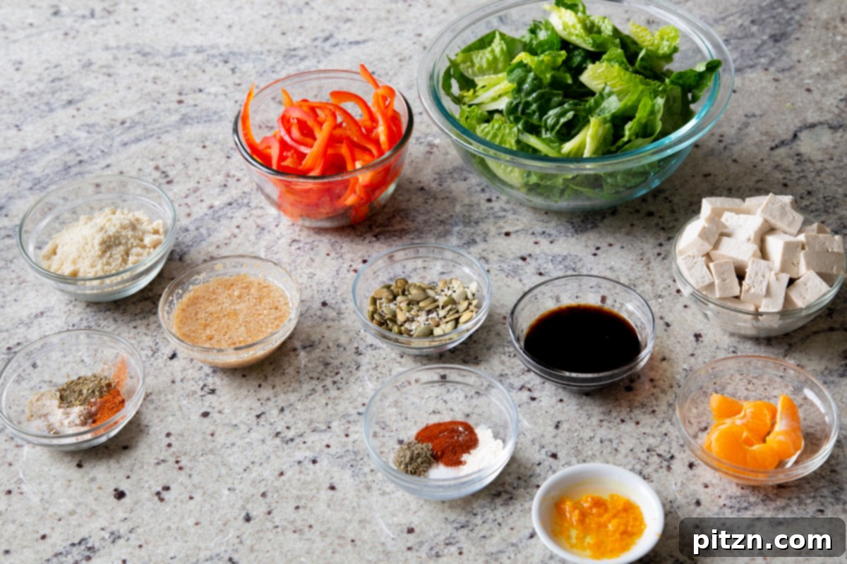 A selection of fresh ingredients for the vegan summer salad, neatly arranged in bowls on a kitchen countertop, showcasing their vibrant colors and readiness for preparation.