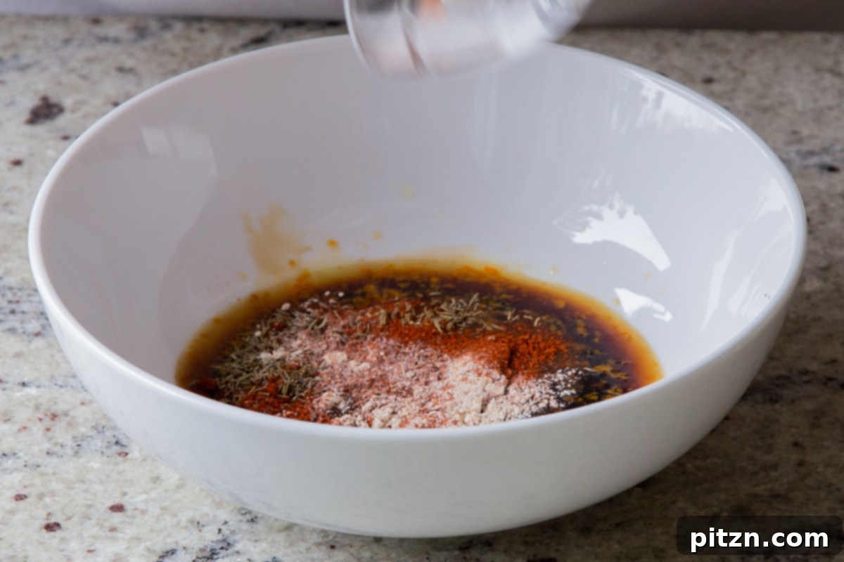 Adding all the liquid and spice ingredients for the vegan summer salad dressing into a large mixing bowl, showcasing the initial step of flavor creation.