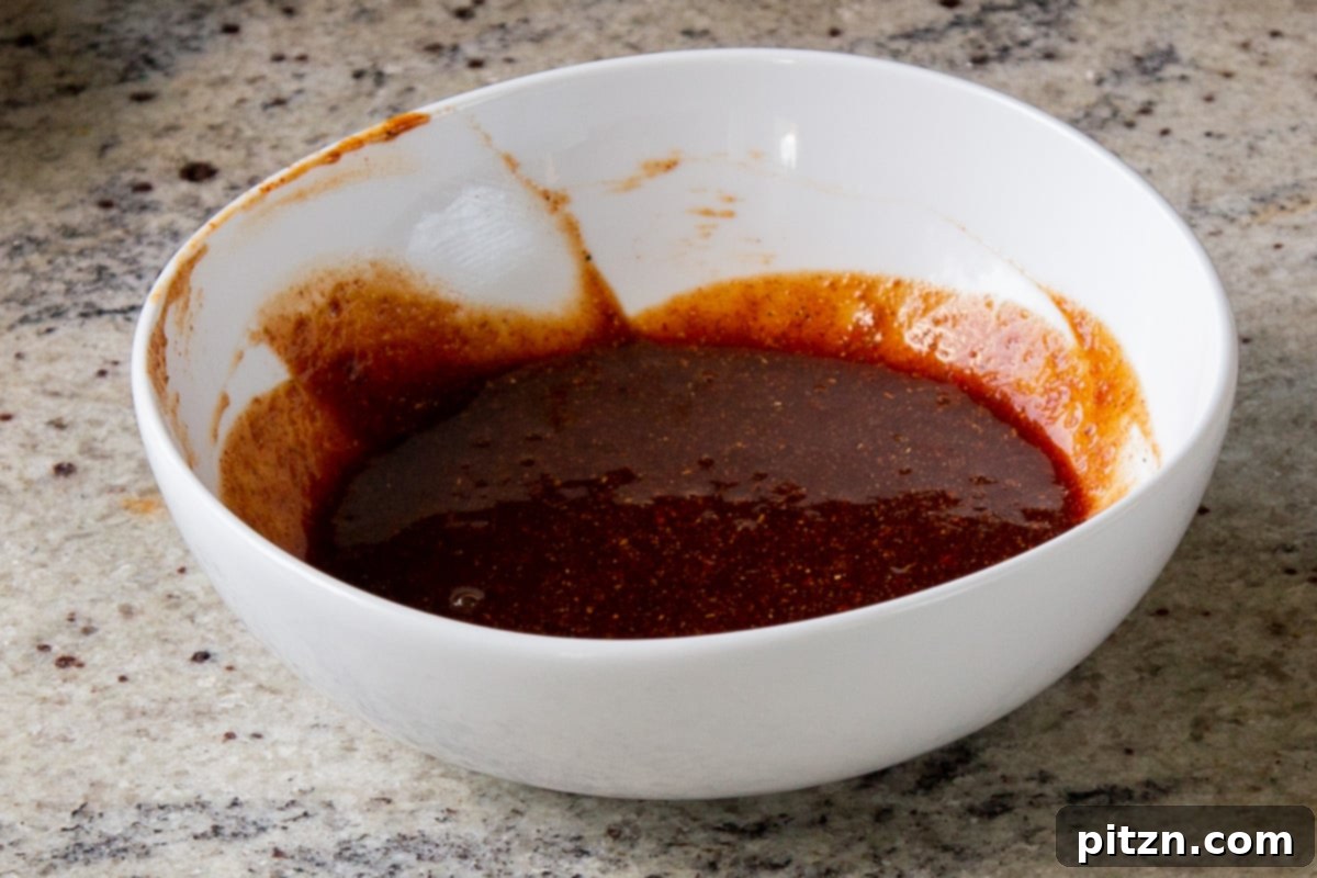 Smoky Chickpea Potato Salad 13 The BBQ dressing ingredients in a bowl after being thoroughly mixed, showing a smooth and vibrant sauce.