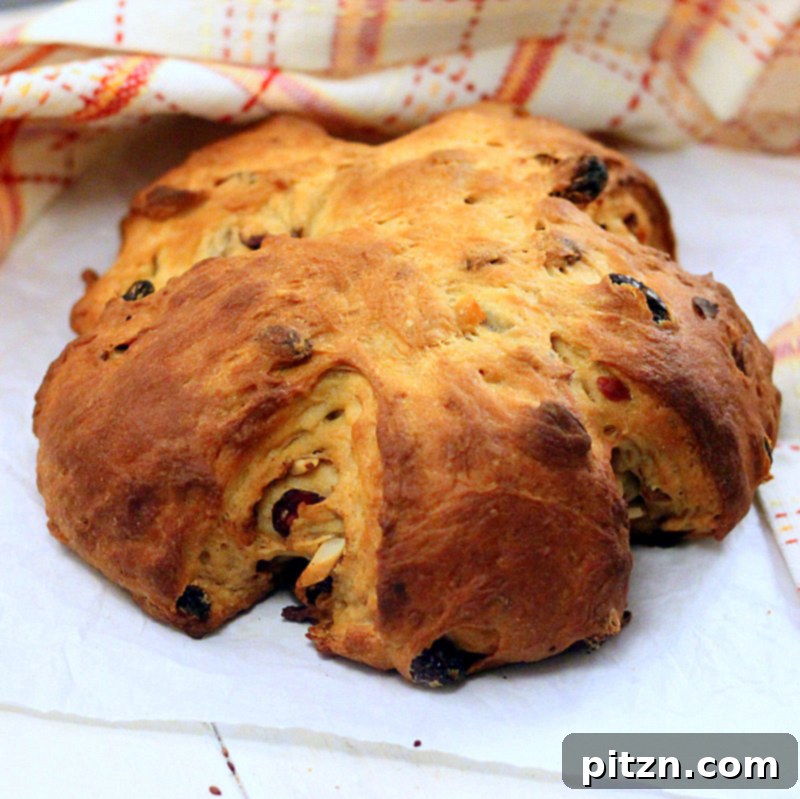 The fully baked Vegan Christmas Stollen Wreath, beautifully presented on a festive table with holiday decorations, ready for slicing and serving.