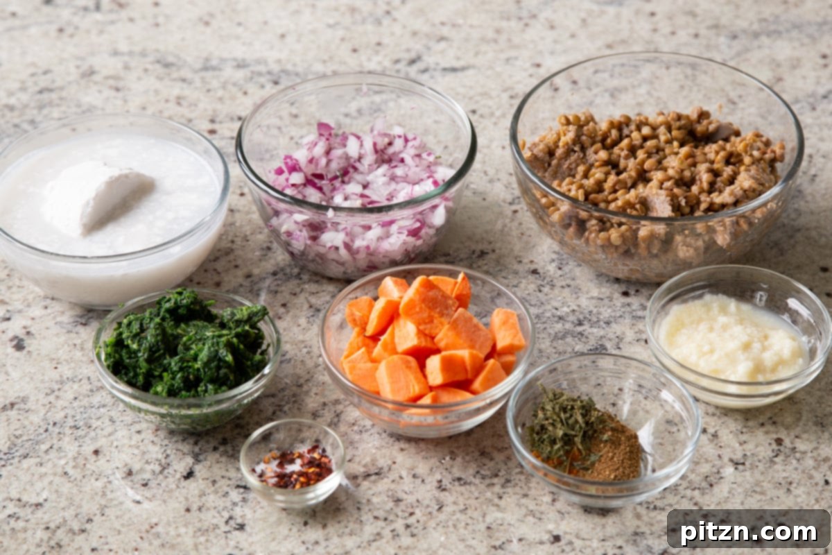 lentils, sweet potatoes, coconut milk, and other curry ingredients in bowls on a kitchen counter