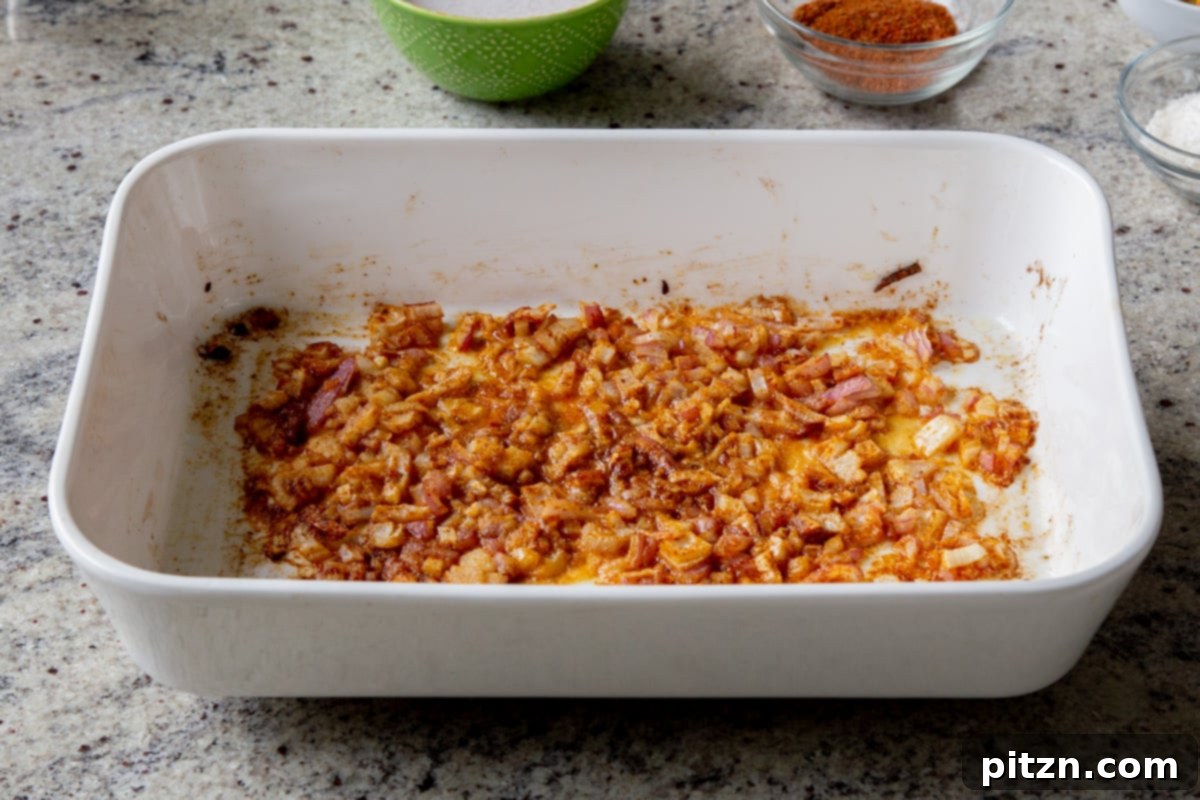 Sheet Pan Konkani Lentil Curry 10 adding onion, ginger, and garlic mixed with the spices in the baking pan, after baking