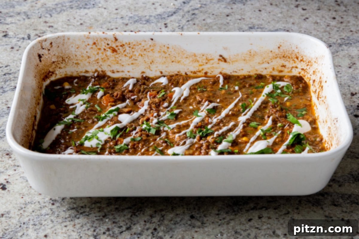 Sheet Pan Konkani Lentil Curry 19 baked Konkani curry topped with coconut cream, cilantro, and pepper flakes in the baking pan