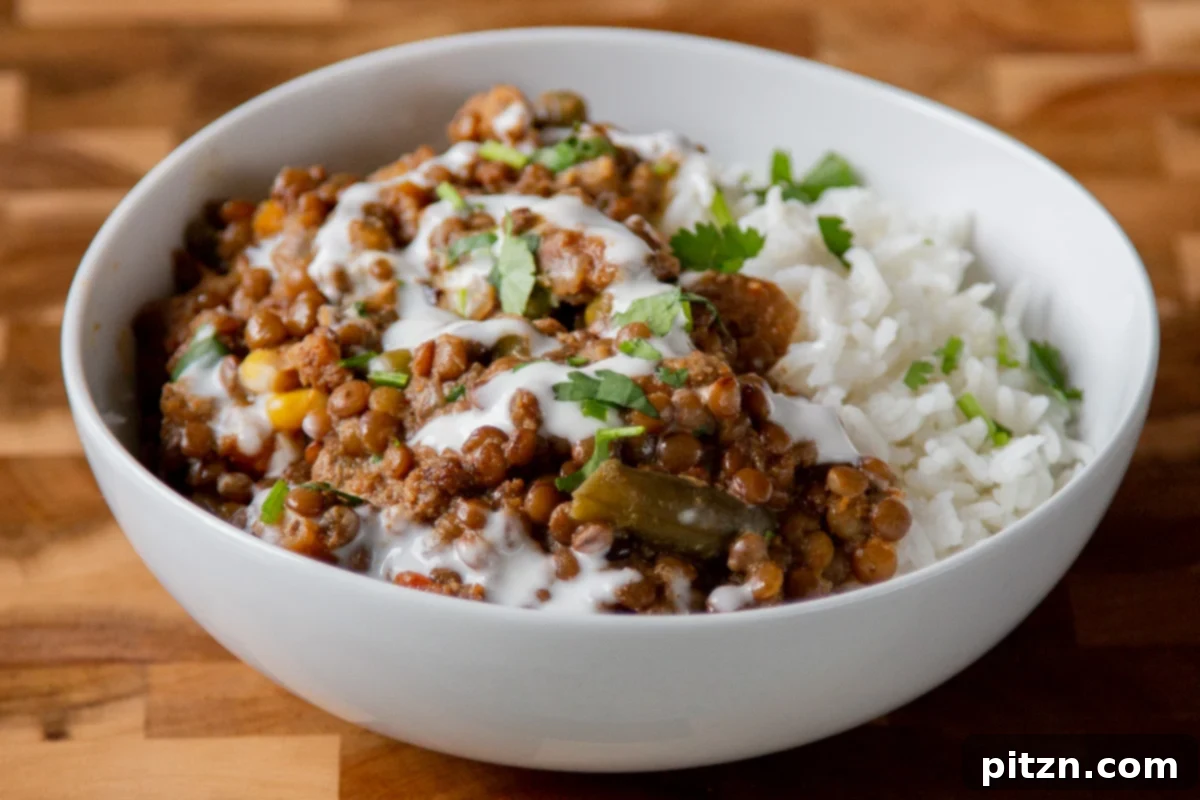 Sheet Pan Konkani Lentil Curry 20 bowl of baked Konkani curry topped with coconut cream, cilantro, and pepper flakes