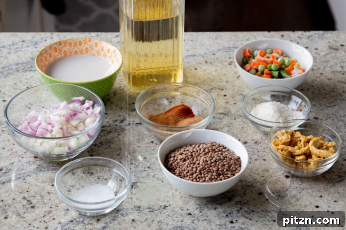 Sheet Pan Konkani Lentil Curry 5 lentils, soy curls, and other curry ingredients in bowls on the kitchen counter