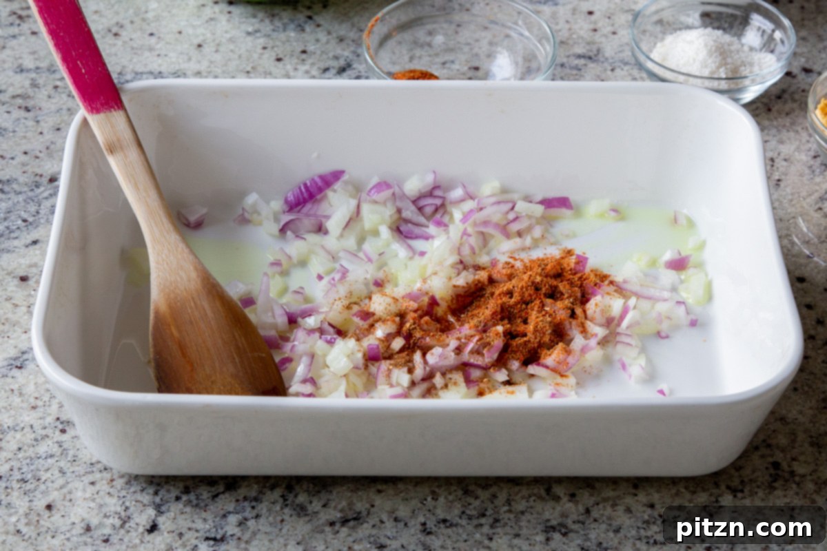 Sheet Pan Konkani Lentil Curry 8 adding onion, ginger, garlic, and spices to the baking pan