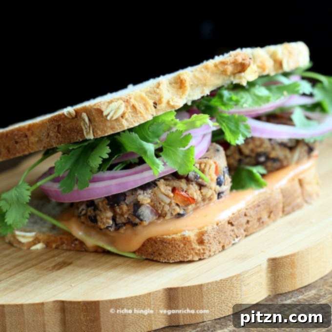 Everyday Vegan Eats Cookbook Reviewed Vegan Pad Thai Put To The Test 6 Savory and hearty Bahn Mi Burger from 'Everyday Vegan Eats'. This plant-based burger is rich in Asian flavors, made with black beans and rice, and perfectly complemented by a sriracha mayo sauce and quick-pickled vegetables, ideal for a satisfying meal.