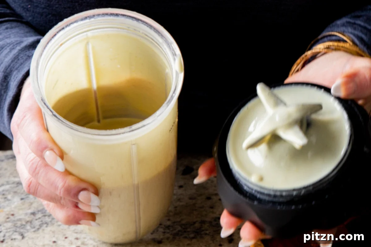 The smooth, pale yellow vegan lemon pudding mixture inside a blender, after thorough blending.
