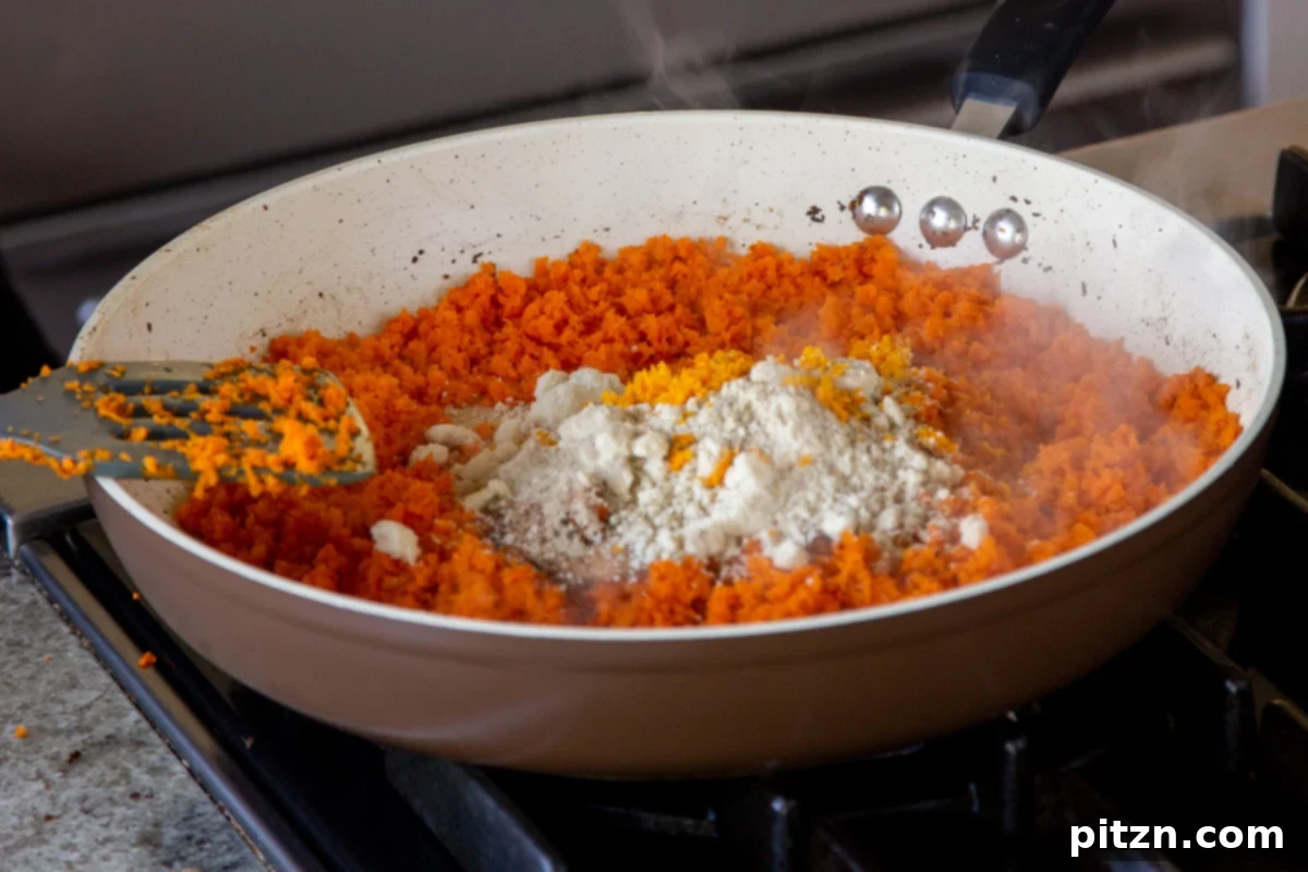 Indian Fusion Grain Free No Bake Carrot Halwa Cheesecake 11 adding almond flour to the pan of grated carrots