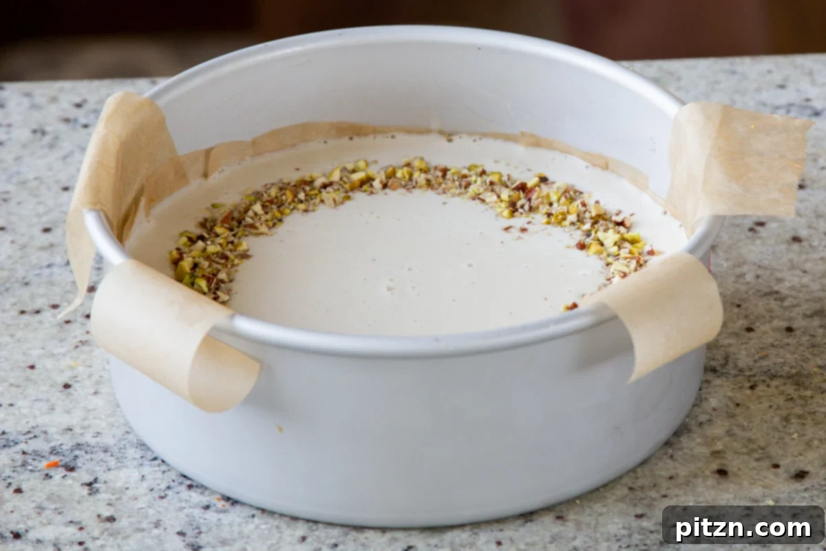 Indian Fusion Grain Free No Bake Carrot Halwa Cheesecake 16 cheesecake layer after spreading into the pan and topping with nuts