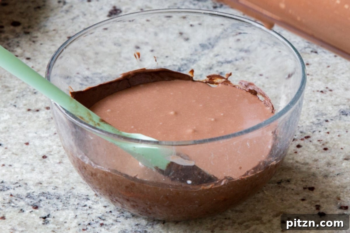 Decadent Easy Vegan Chocolate Pudding Soy Gluten Nut Free 10 Adding a portion of the prepared vegan mousse to the bowl of melted chocolate chips.
