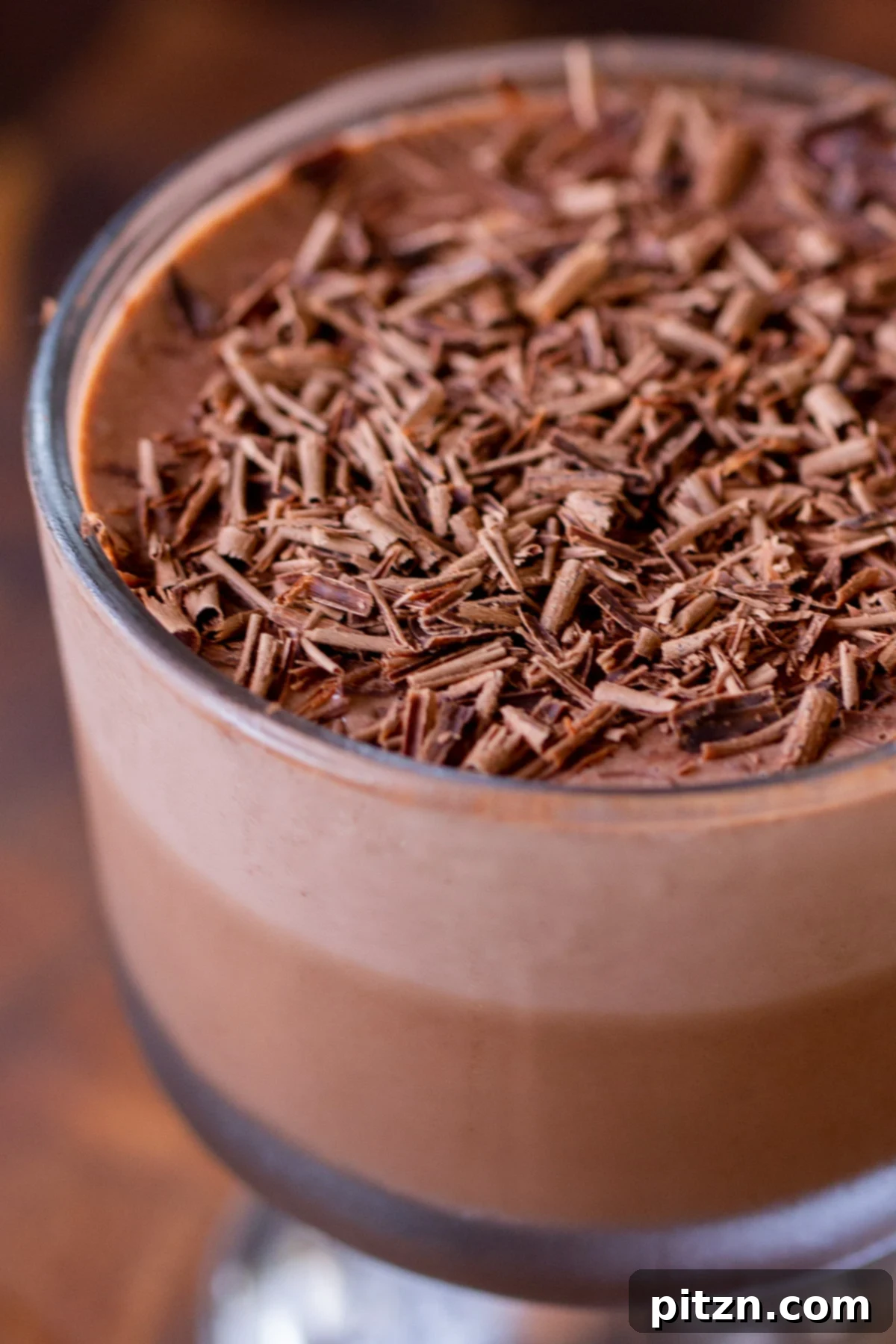 Decadent Easy Vegan Chocolate Pudding Soy Gluten Nut Free 3 Close-up of vegan chocolate pudding with chocolate shavings on top, highlighting its rich texture.