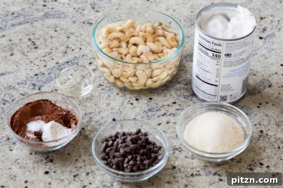 Decadent Easy Vegan Chocolate Pudding Soy Gluten Nut Free 6 Bowls of cashews, chocolate chips, and other vegan pudding ingredients laid out on a kitchen counter