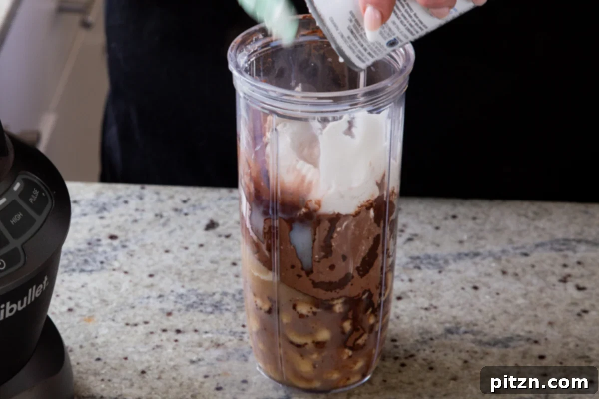 Decadent Easy Vegan Chocolate Pudding Soy Gluten Nut Free 7 Adding coconut cream to the blender with the other chocolate pudding ingredients, preparing the mousse base.