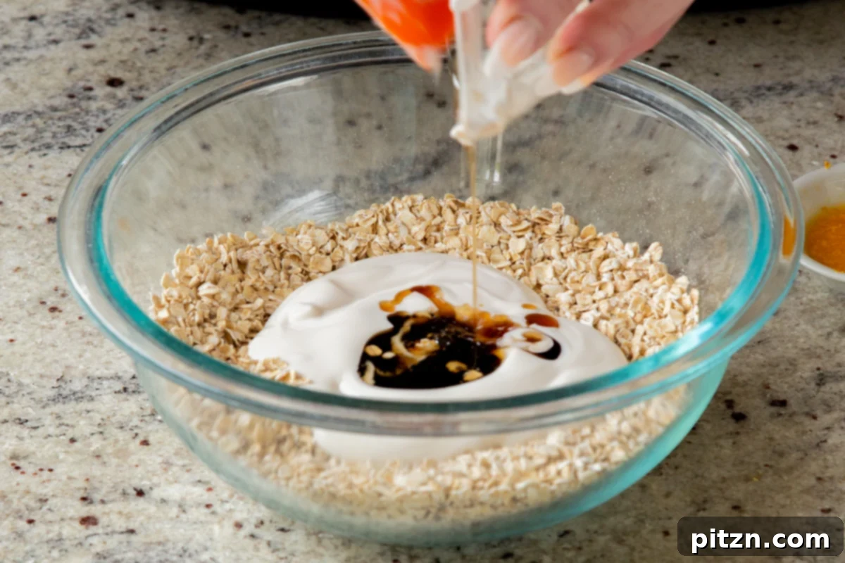 Easy Cannoli Overnight Oats: 30-Minute, Gluten-Free & Soy-Free 10 Adding non-dairy yogurt and maple syrup into the glass bowl containing the dry oat and chia seed mixture.